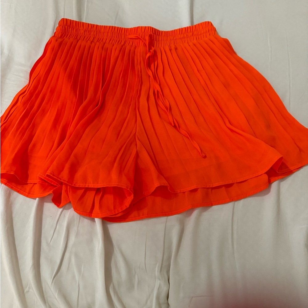 Orange pleated shorts